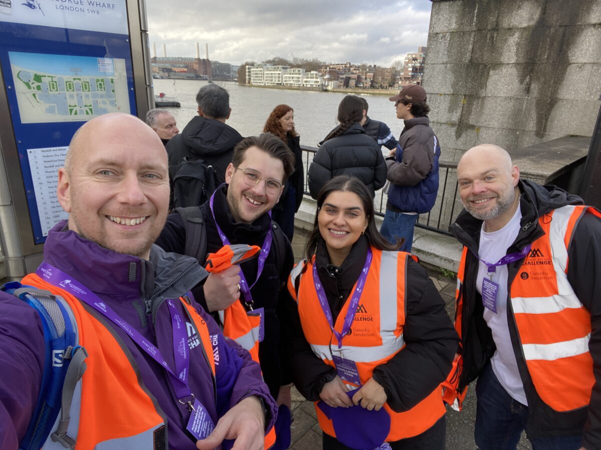 Image of the Gatenbysanderson team standing on a london bridge smiling to camera